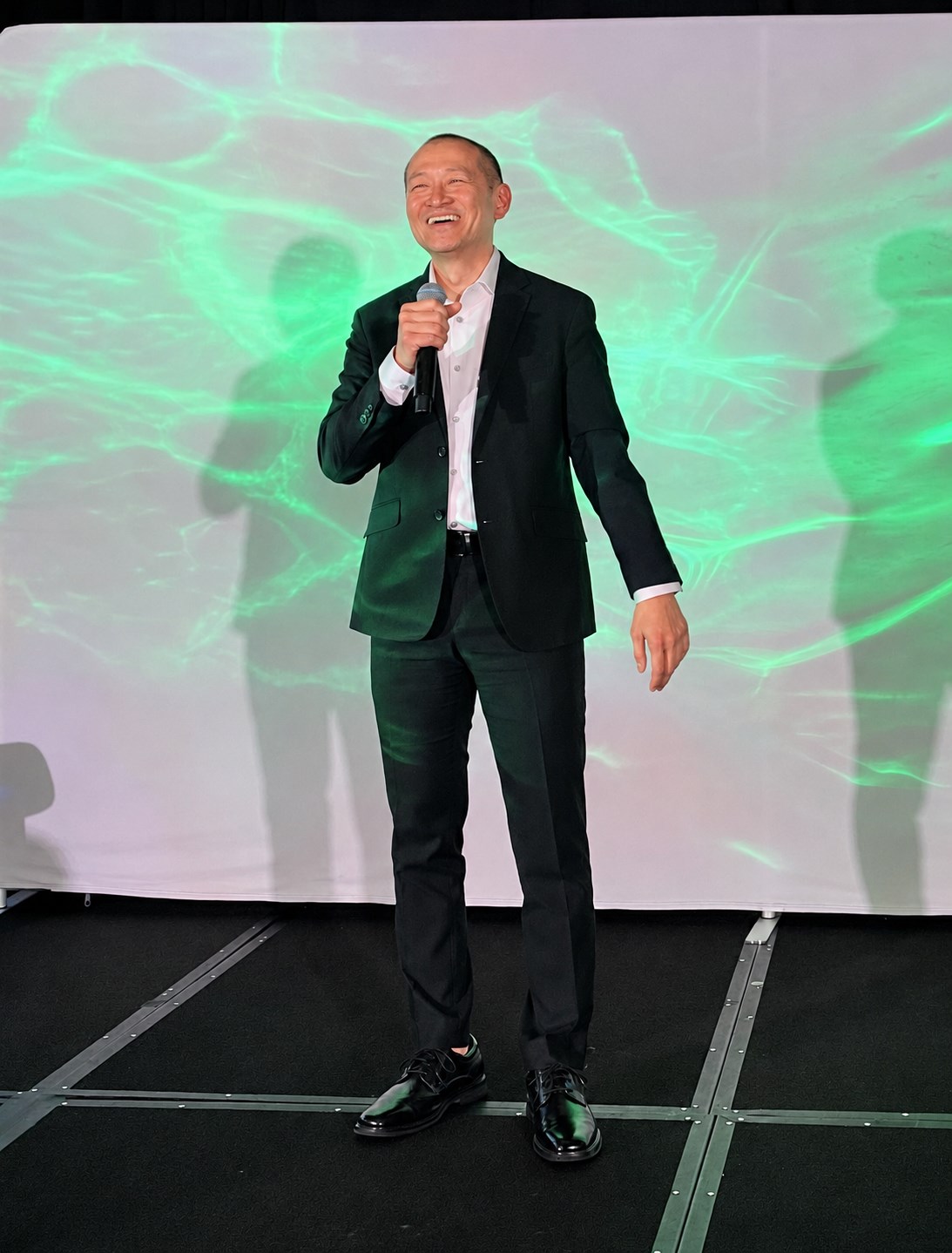 Regie Tiu speaking on stage